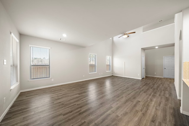 9993 Mountain Lion Ln, Magnolia, TX 77354 - unfurnished living room with dark wood-style floors, a ceiling fan, a wealth of natural light, and baseboards