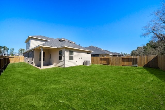 9993 Mountain Lion Ln, Magnolia, TX 77354 - rear view of property with a patio, central AC unit, a yard, a fenced backyard, and roof with shingles