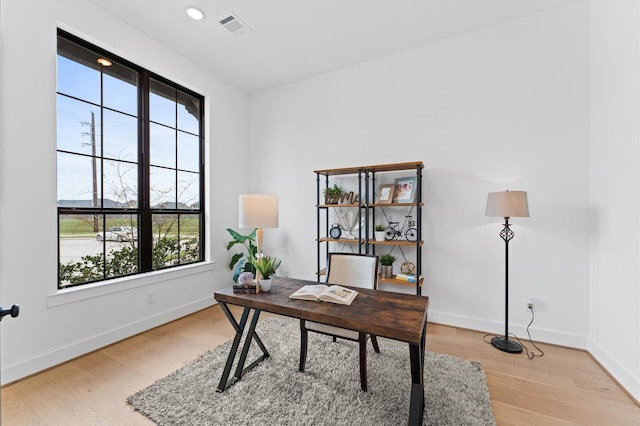 office with visible vents, light wood-style flooring, and baseboards