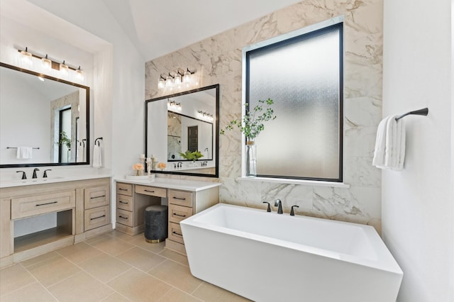 bathroom with a soaking tub, tile walls, and vanity