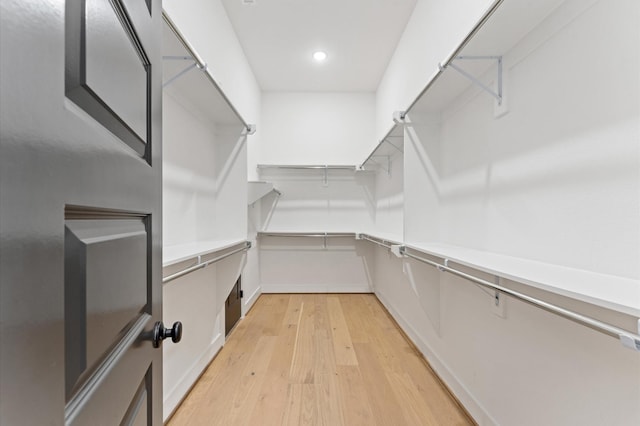 walk in closet with light wood-type flooring