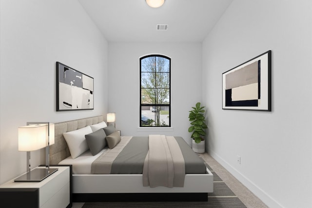 bedroom featuring dark carpet, visible vents, and baseboards