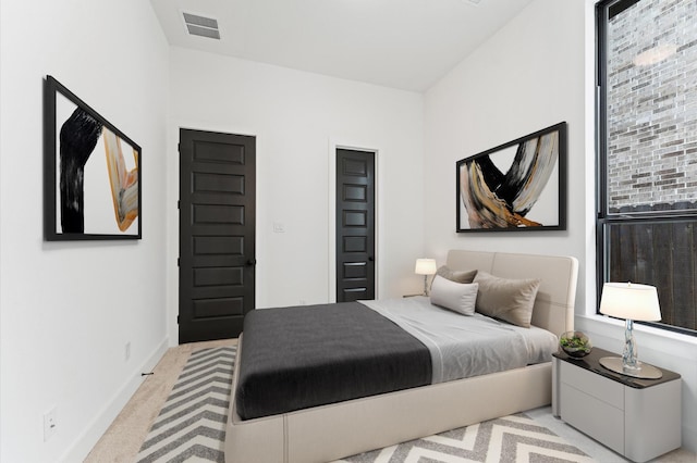 carpeted bedroom with baseboards and visible vents