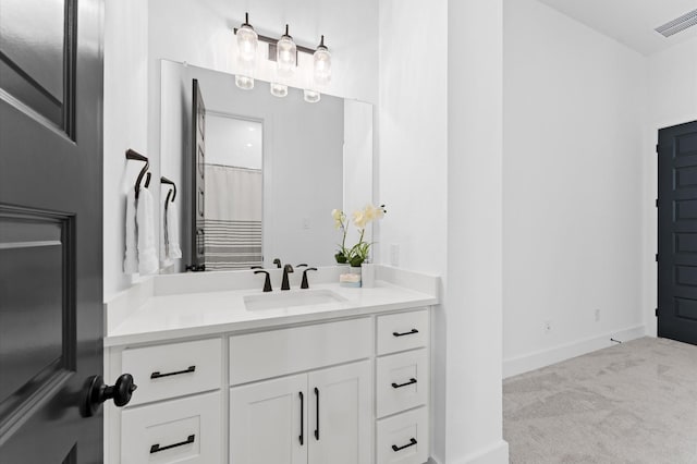 bathroom with baseboards, visible vents, and vanity