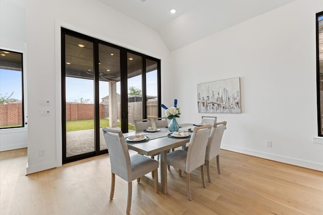 dining area with recessed lighting, baseboards, lofted ceiling, and light wood-style floors