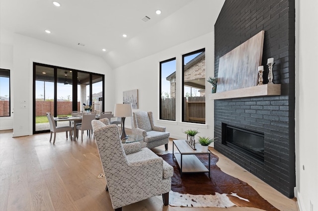 living area with visible vents, wood finished floors, a fireplace, and recessed lighting