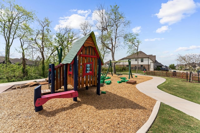 community jungle gym featuring fence and a yard