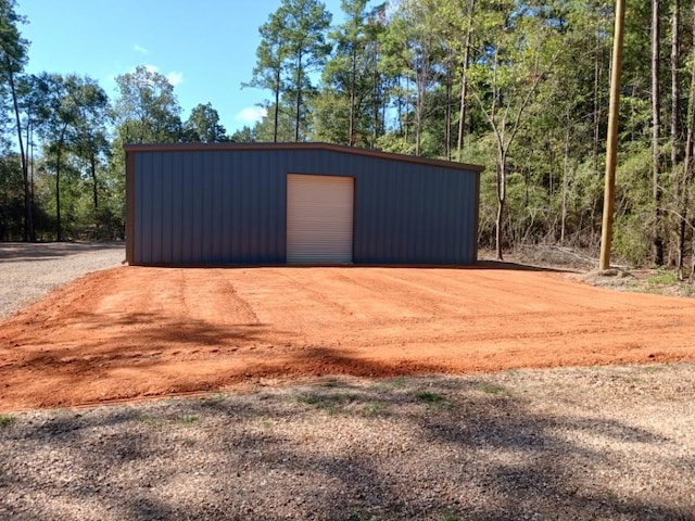 detached garage with dirt driveway