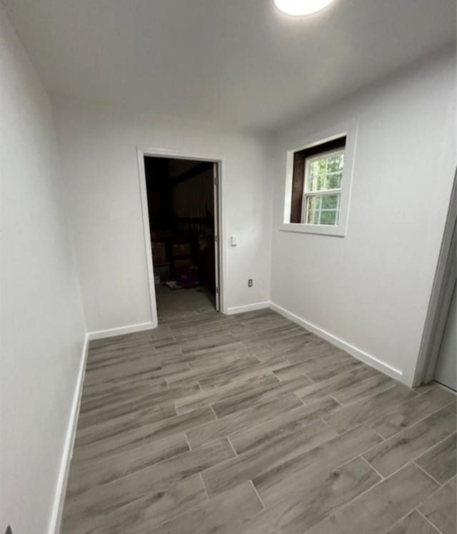 empty room with wood finished floors and baseboards