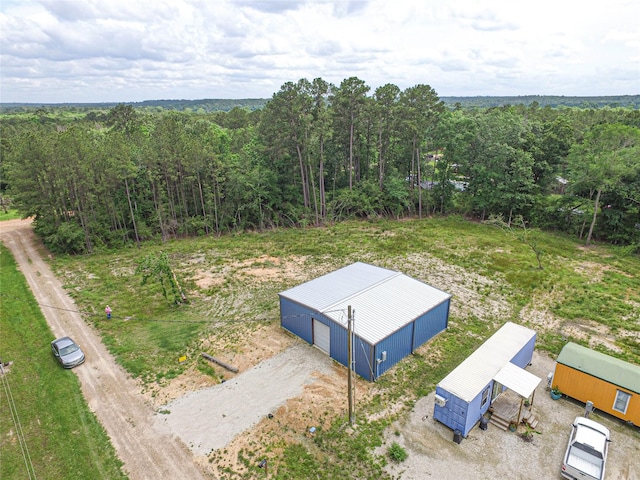 bird's eye view featuring a wooded view