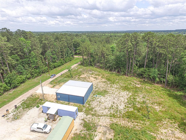 bird's eye view featuring a wooded view
