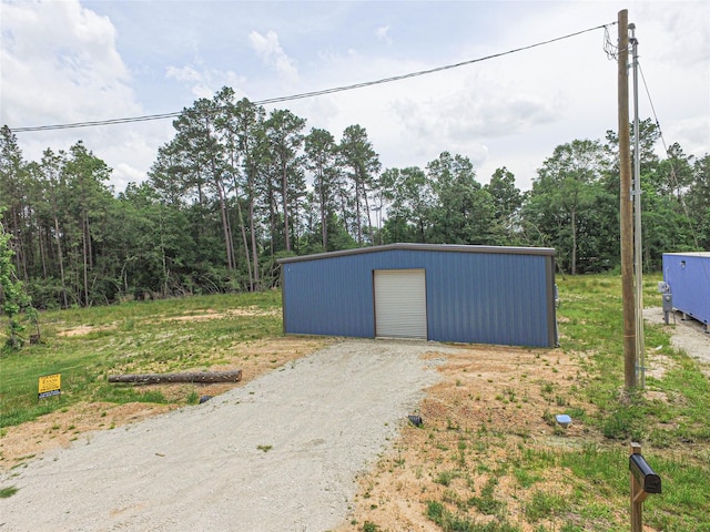 detached garage with gravel driveway