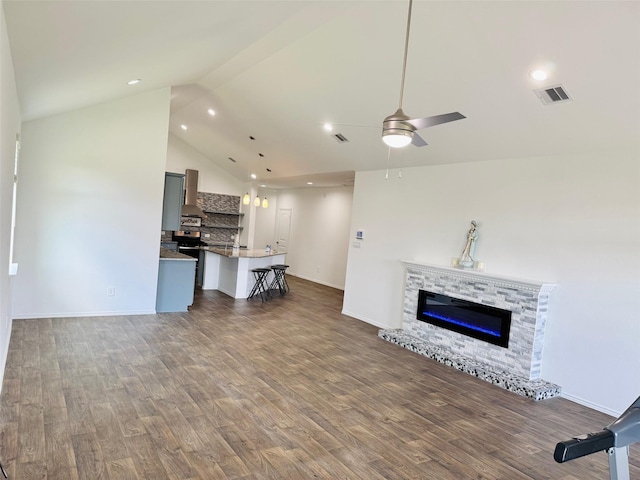 unfurnished living room with a fireplace, a ceiling fan, recessed lighting, wood finished floors, and visible vents