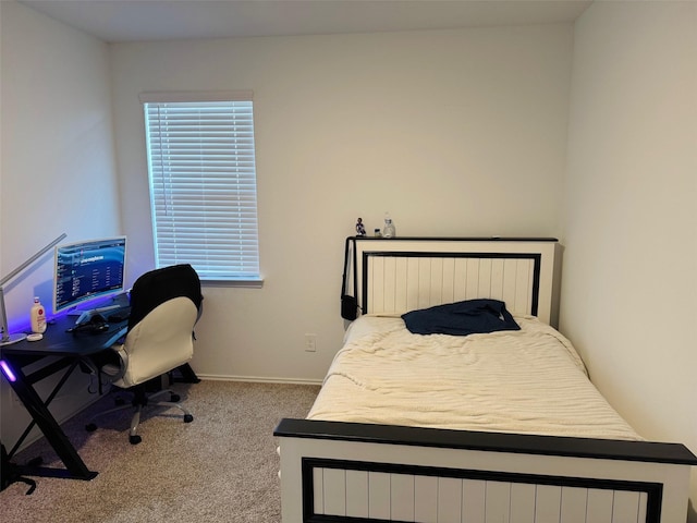 carpeted bedroom featuring baseboards