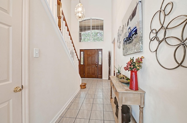 5127 Plantation Colony Dr, Sugar Land, TX 77478 - entrance foyer with a high ceiling, light tile patterned floors, stairs, and baseboards