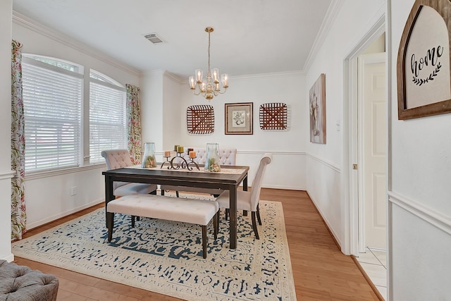 5127 Plantation Colony Dr, Sugar Land, TX 77478 - dining space featuring a chandelier, plenty of natural light, light wood-style flooring, and crown molding
