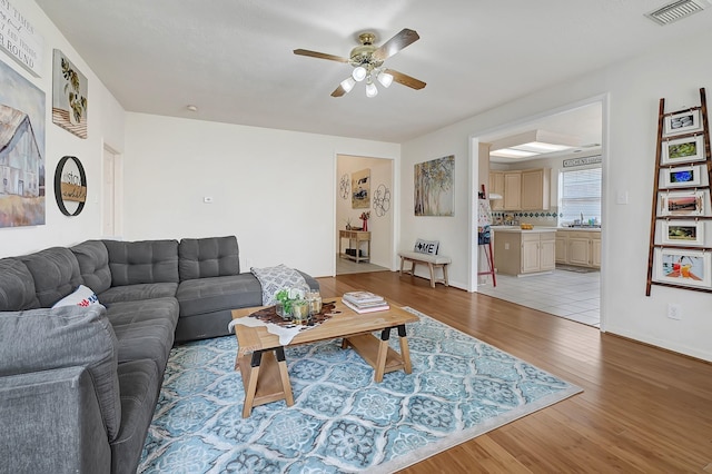 5127 Plantation Colony Dr, Sugar Land, TX 77478 - living room featuring ceiling fan, light wood-style flooring, and baseboards