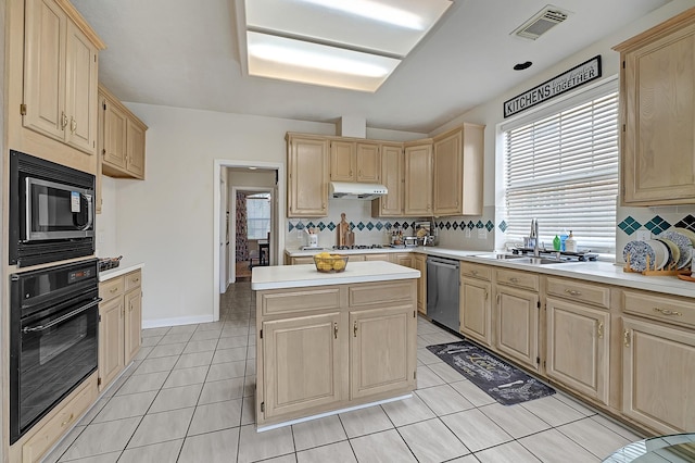 5127 Plantation Colony Dr, Sugar Land, TX 77478 - kitchen with appliances with stainless steel finishes, light brown cabinets, a sink, under cabinet range hood, and backsplash