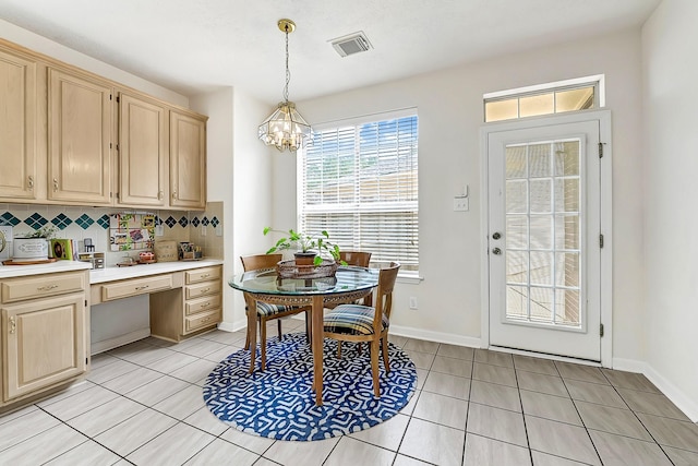 5127 Plantation Colony Dr, Sugar Land, TX 77478 - dining room featuring light tile patterned flooring, a chandelier, baseboards, and built in study area