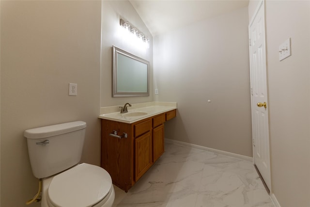 half bath featuring vanity, marble finish floor, baseboards, and toilet