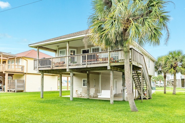 rear view of property featuring a deck, stairs, a yard, and a patio area