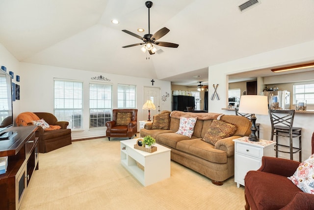 living room with light colored carpet, visible vents, ceiling fan, recessed lighting, and vaulted ceiling