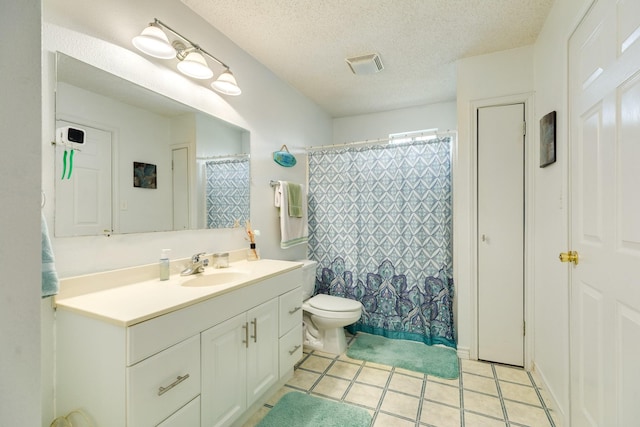 full bathroom with tile patterned flooring, toilet, vanity, visible vents, and a textured ceiling