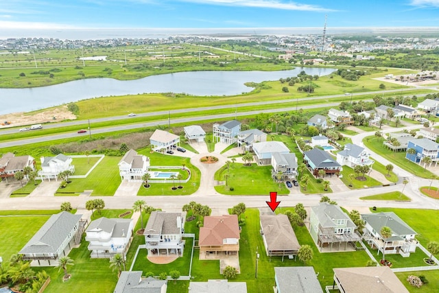 drone / aerial view with a residential view and a water view