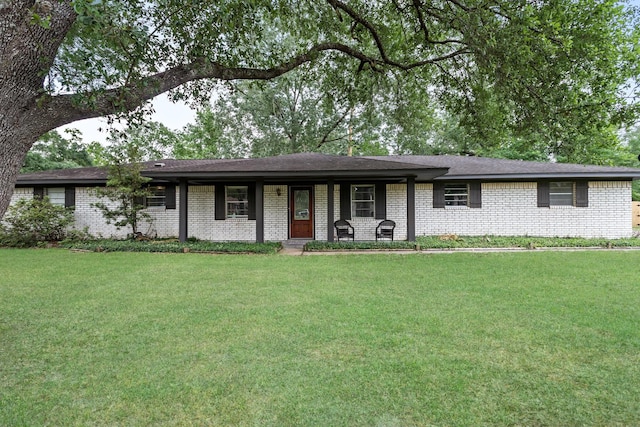 343 Pinemont Dr, Sour Lake, TX 77659 - ranch-style house with a porch, a front yard, and brick siding