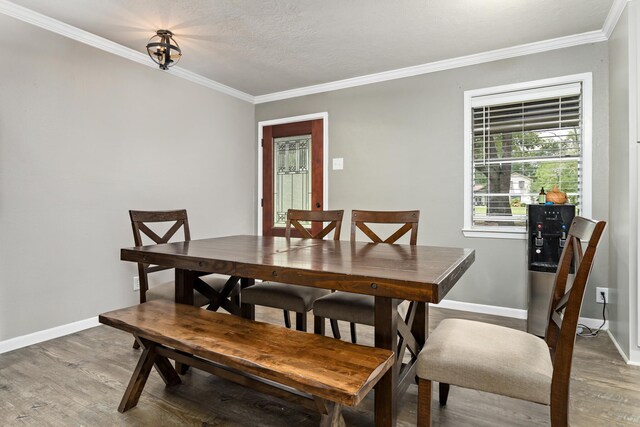 343 Pinemont Dr, Sour Lake, TX 77659 - dining room with baseboards, ornamental molding, and light wood finished floors