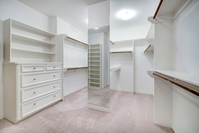 walk in closet featuring light colored carpet