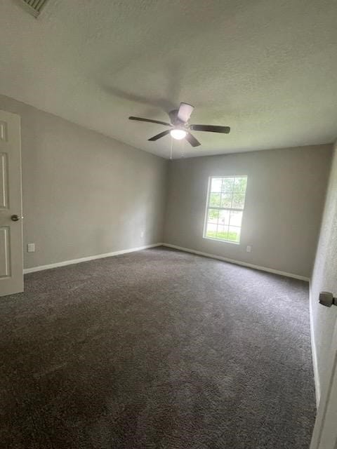 carpeted empty room with baseboards and ceiling fan