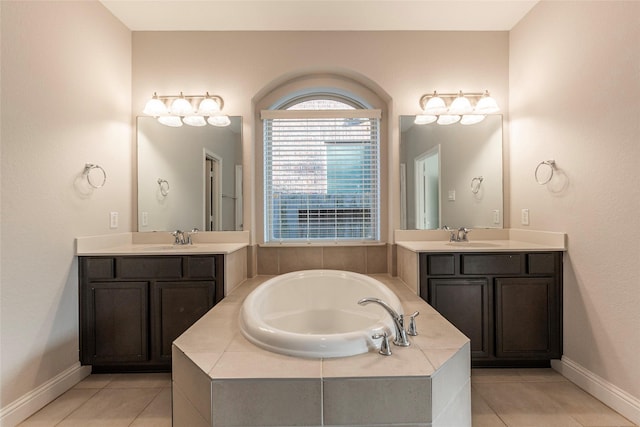 3302 Indigo Acres Ct, Katy, TX 77494 - bathroom featuring a sink, a bath, two vanities, baseboards, and tile patterned flooring