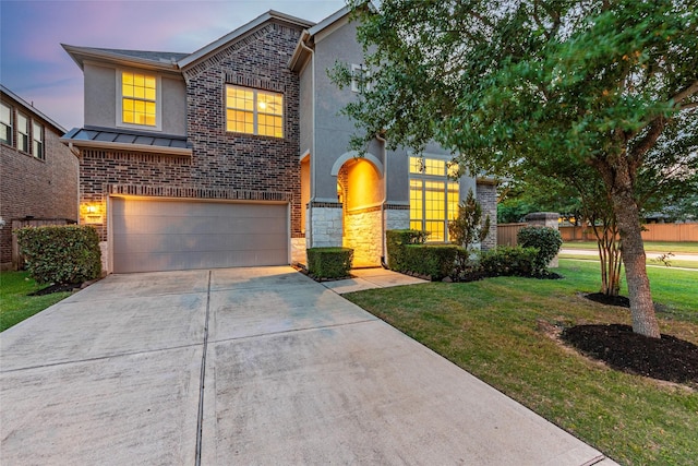 3302 Indigo Acres Ct, Katy, TX 77494 - traditional-style home featuring a standing seam roof, stucco siding, a lawn, concrete driveway, and an attached garage