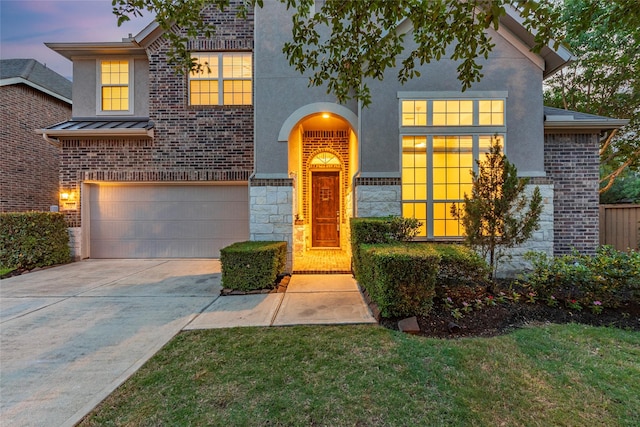 3302 Indigo Acres Ct, Katy, TX 77494 - traditional-style home featuring a garage, a standing seam roof, stucco siding, and driveway