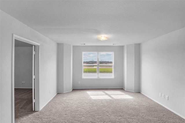 unfurnished room featuring baseboards and carpet