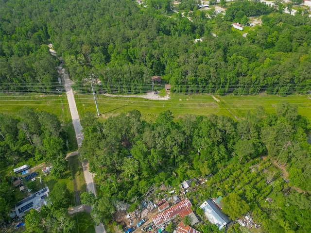 birds eye view of property featuring a forest view