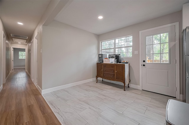 entrance foyer with a healthy amount of sunlight, visible vents, and baseboards