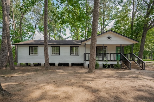 view of front of house with covered porch and roof with shingles