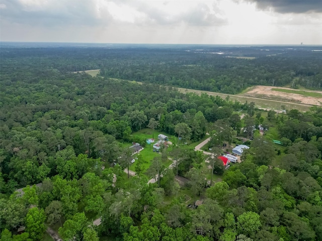 bird's eye view with a wooded view
