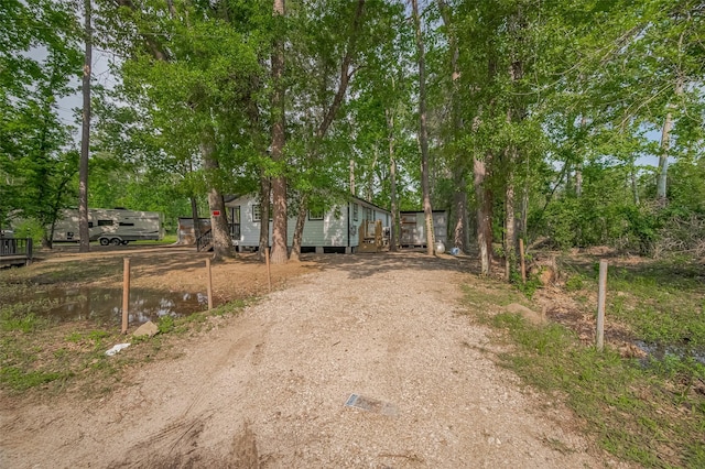 exterior space featuring a wooden deck and driveway