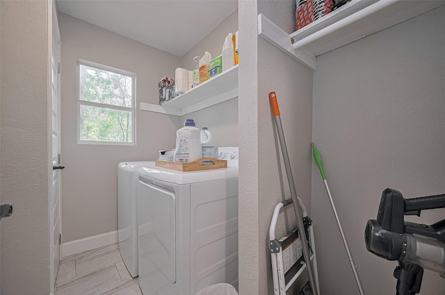 laundry room with independent washer and dryer, marble finish floor, laundry area, and baseboards