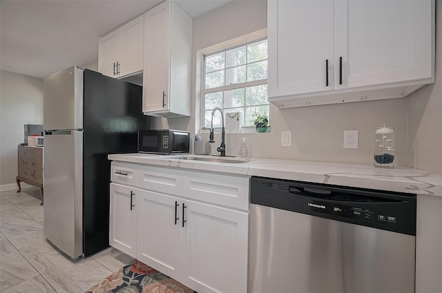 kitchen featuring marble finish floor, a sink, white cabinetry, and stainless steel appliances