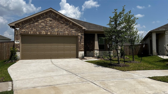 single story home with a garage, driveway, stone siding, brick siding, and fence