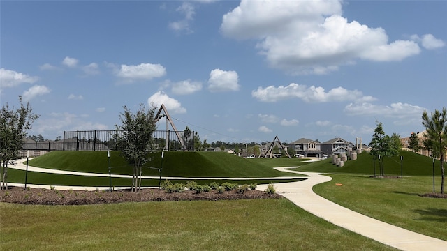 view of home's community featuring fence, a residential view, and a yard