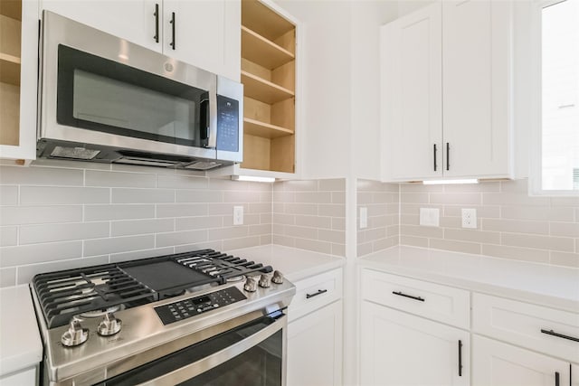 kitchen with open shelves, decorative backsplash, light countertops, white cabinetry, and stainless steel appliances