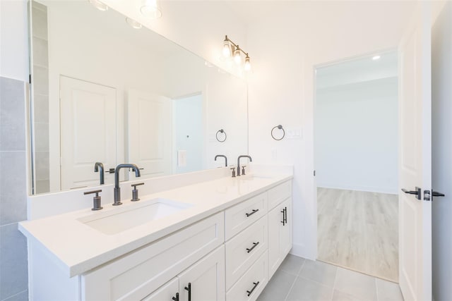 bathroom featuring double vanity, tile patterned floors, and a sink