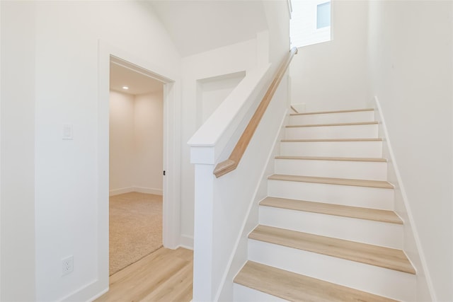 stairs featuring baseboards and wood finished floors