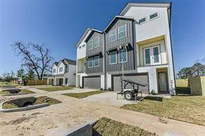 view of property featuring concrete driveway, board and batten siding, and a garage