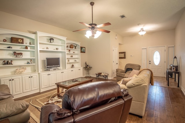 living area with visible vents, a ceiling fan, baseboards, and dark wood-style floors